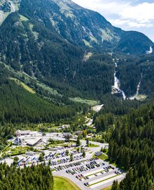 Luftaufnahme mit Blick auf den Parkplatz und im Hintergrund die Krimmler Wasserfälle | © krimmler-wasserwelten.at/Stabentheiner